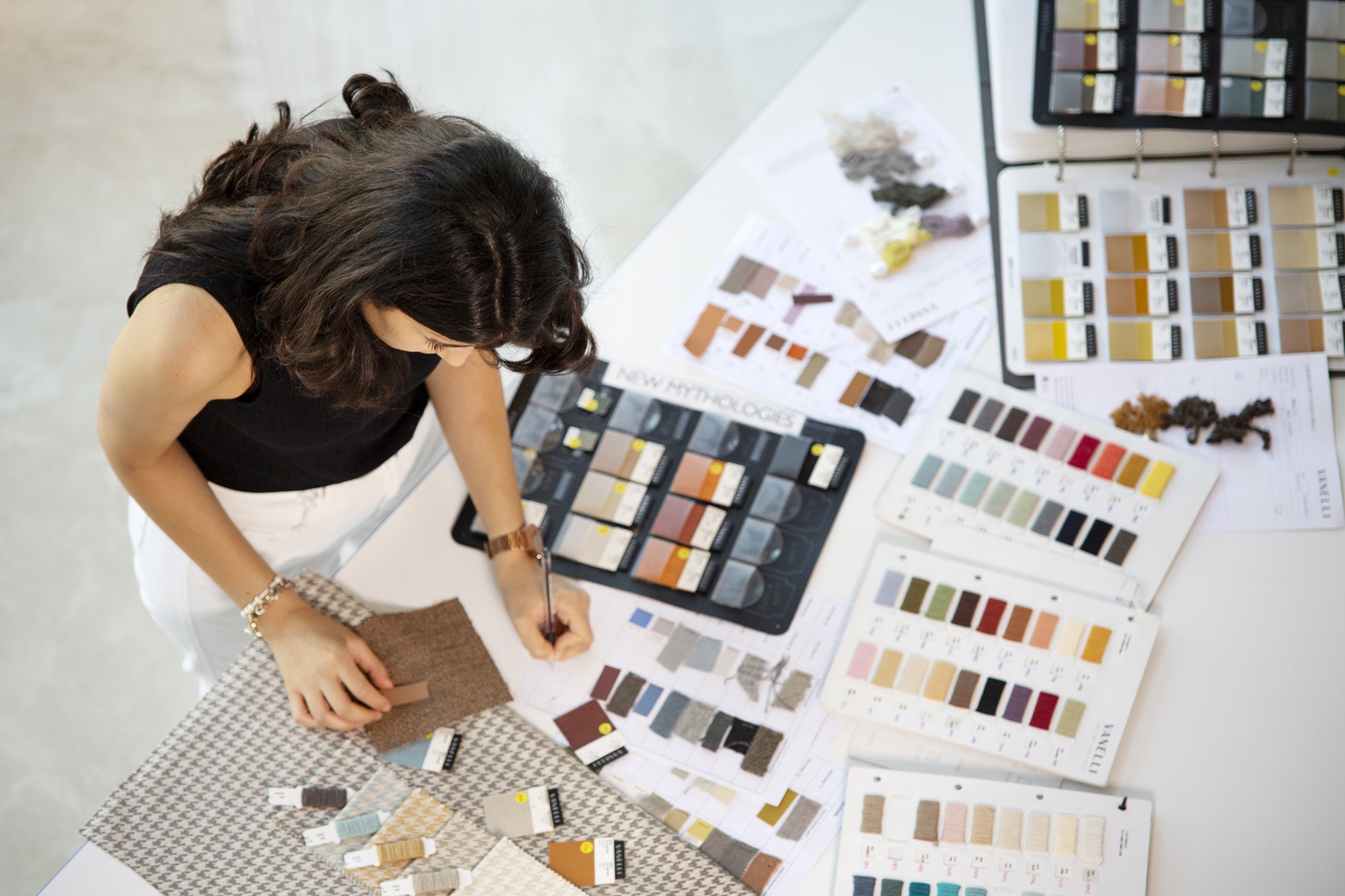 aerial shot of woman looking at fabric colors
