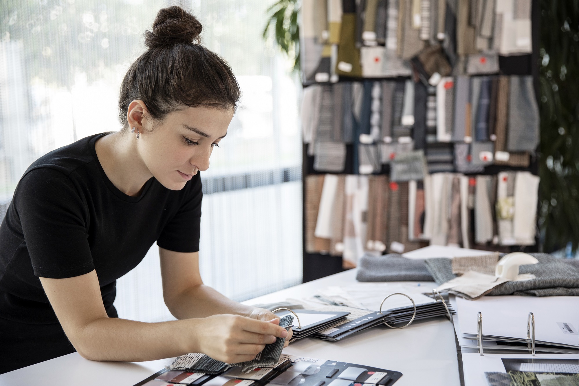 Woman is working on fabric color chart