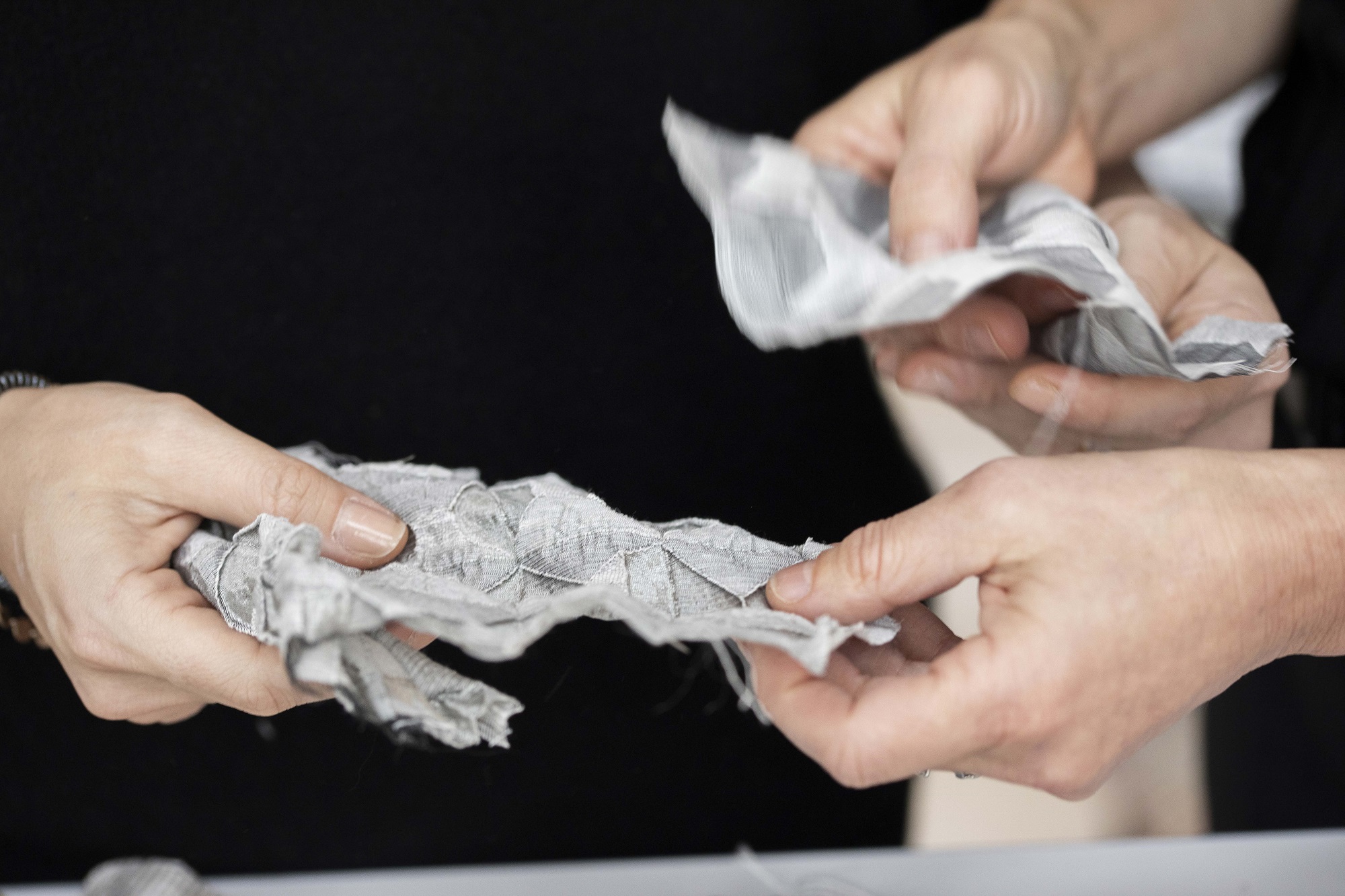 hands touching fabrics