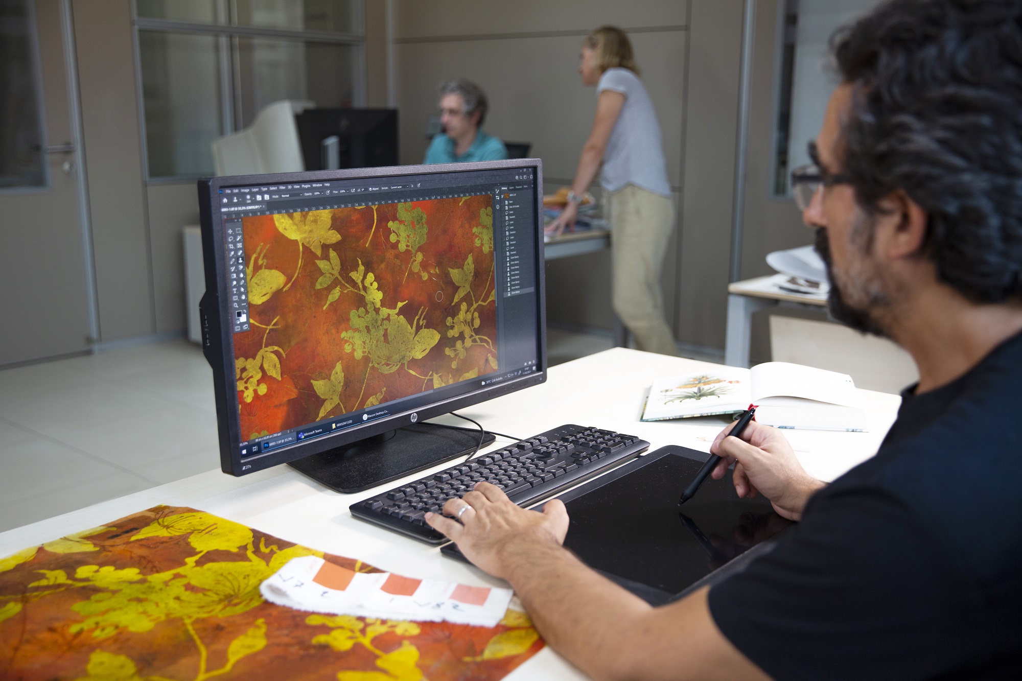 Man is drawing a new fabric design