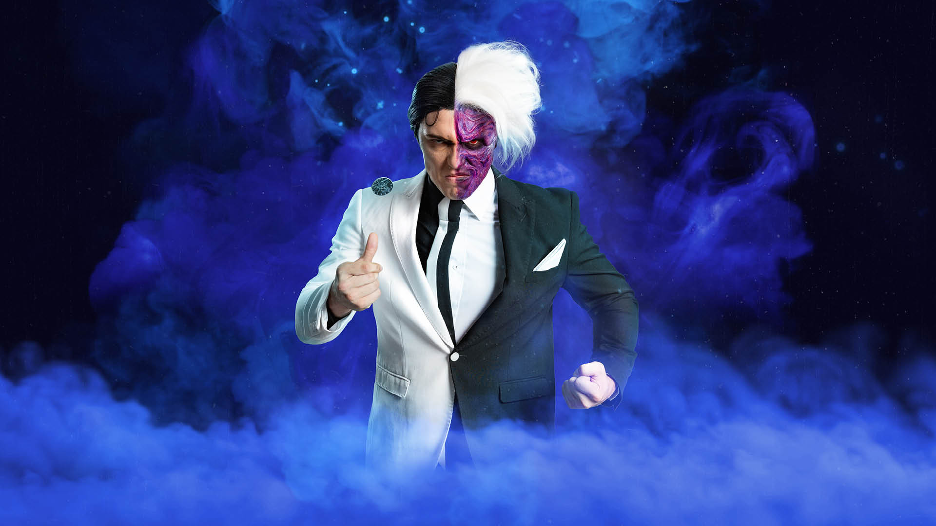 A person dressed as Two-Face from Batman, wearing a suit split into black and white halves, with one side of their face painted purple and scarred, surrounded by green smoke.