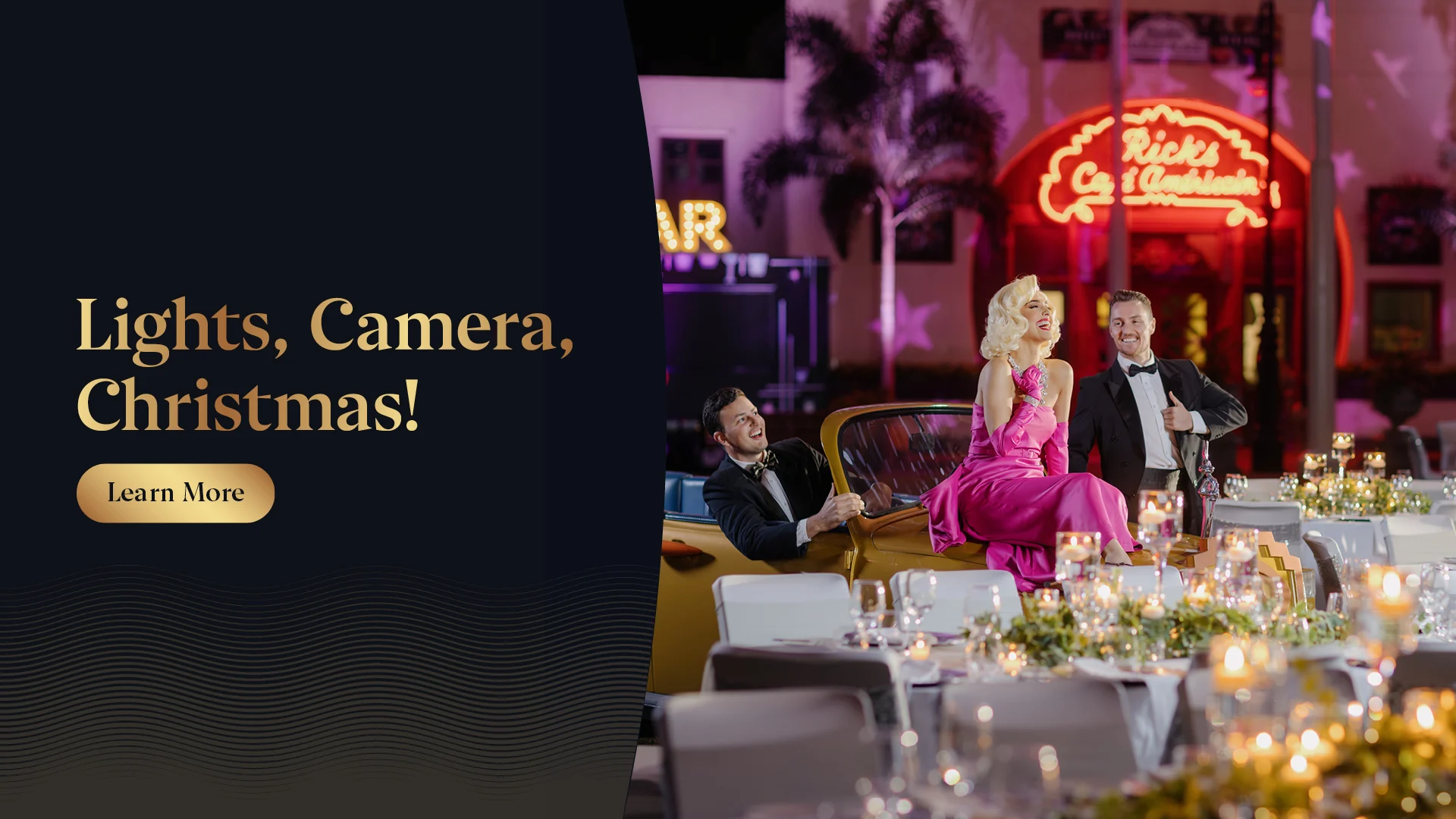 A glamorous holiday event scene with elegant tables set for dinner and three people dressed in formal attire, including a woman in a pink gown, posing in front of a neon-lit diner at night. Text reads “Lights, Camera, Christmas!”.