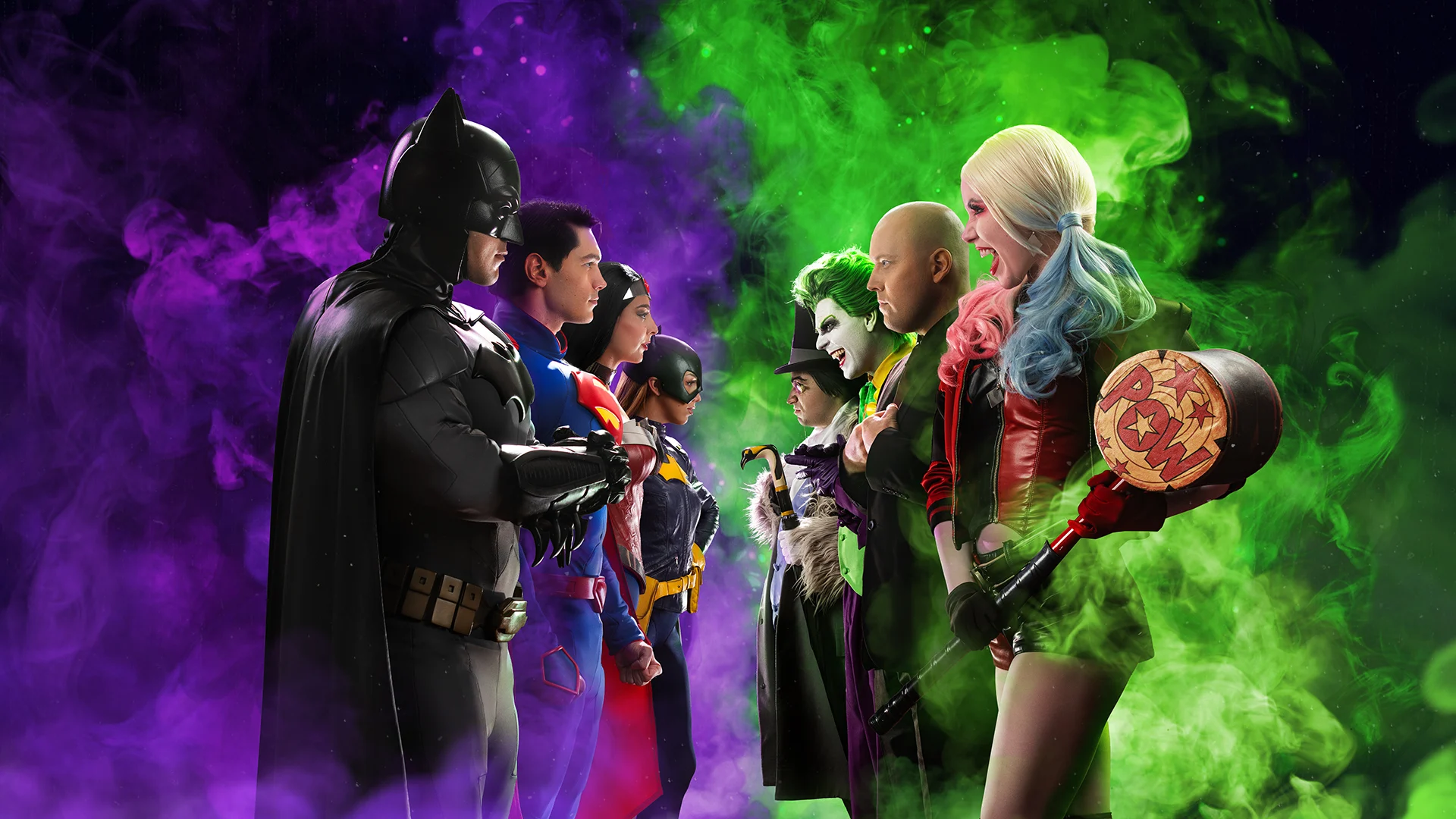 Two rows of DC Comics superheroes and villains face each other amid purple and green smoke, including characters resembling Batman, Superman, Joker, and Harley Quinn.
