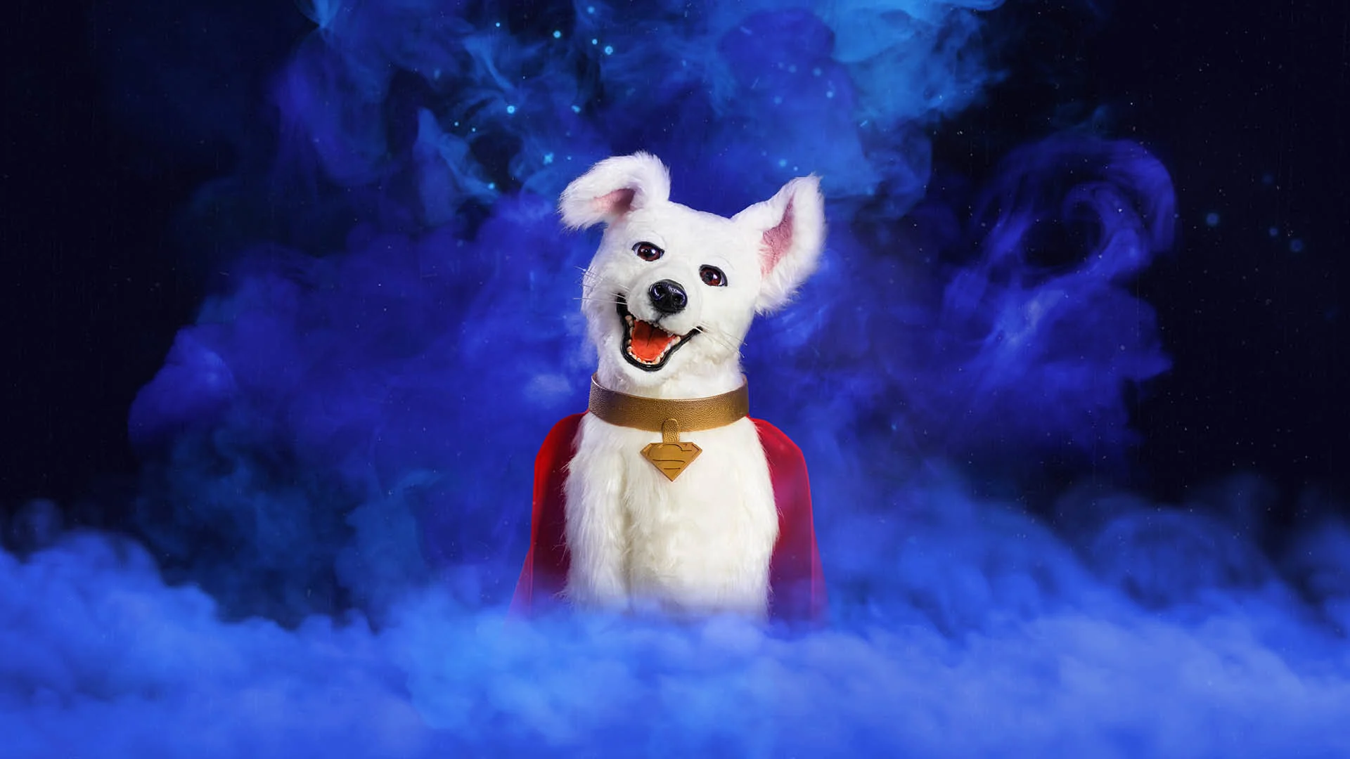 A white dog with perked ears, wearing a red cape and gold collar with a tag, stands against a smoky blue and black cosmic background.