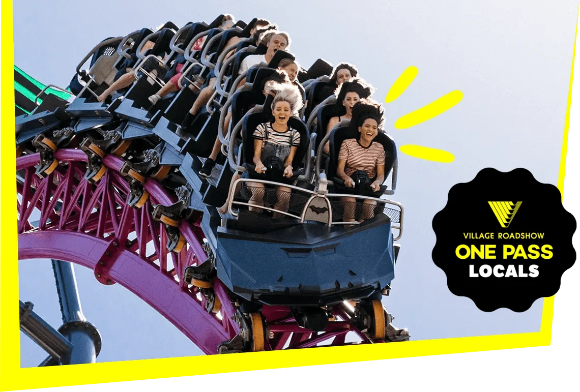 Thrill-seekers riding a high-speed roller coaster on pink tracks at a Village Roadshow theme park, promoted with the One Pass Locals deal.