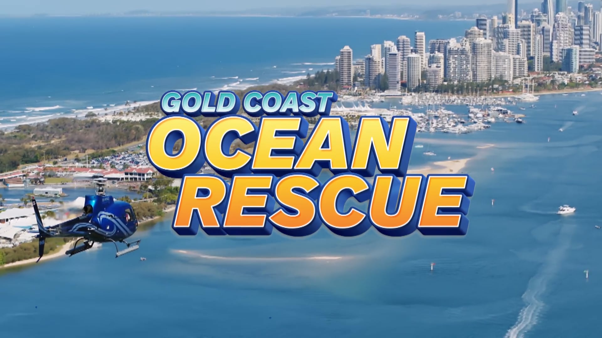A helicopter flies over the Gold Coast shoreline with city buildings in the background; large text reads "Gold Coast Ocean Rescue.