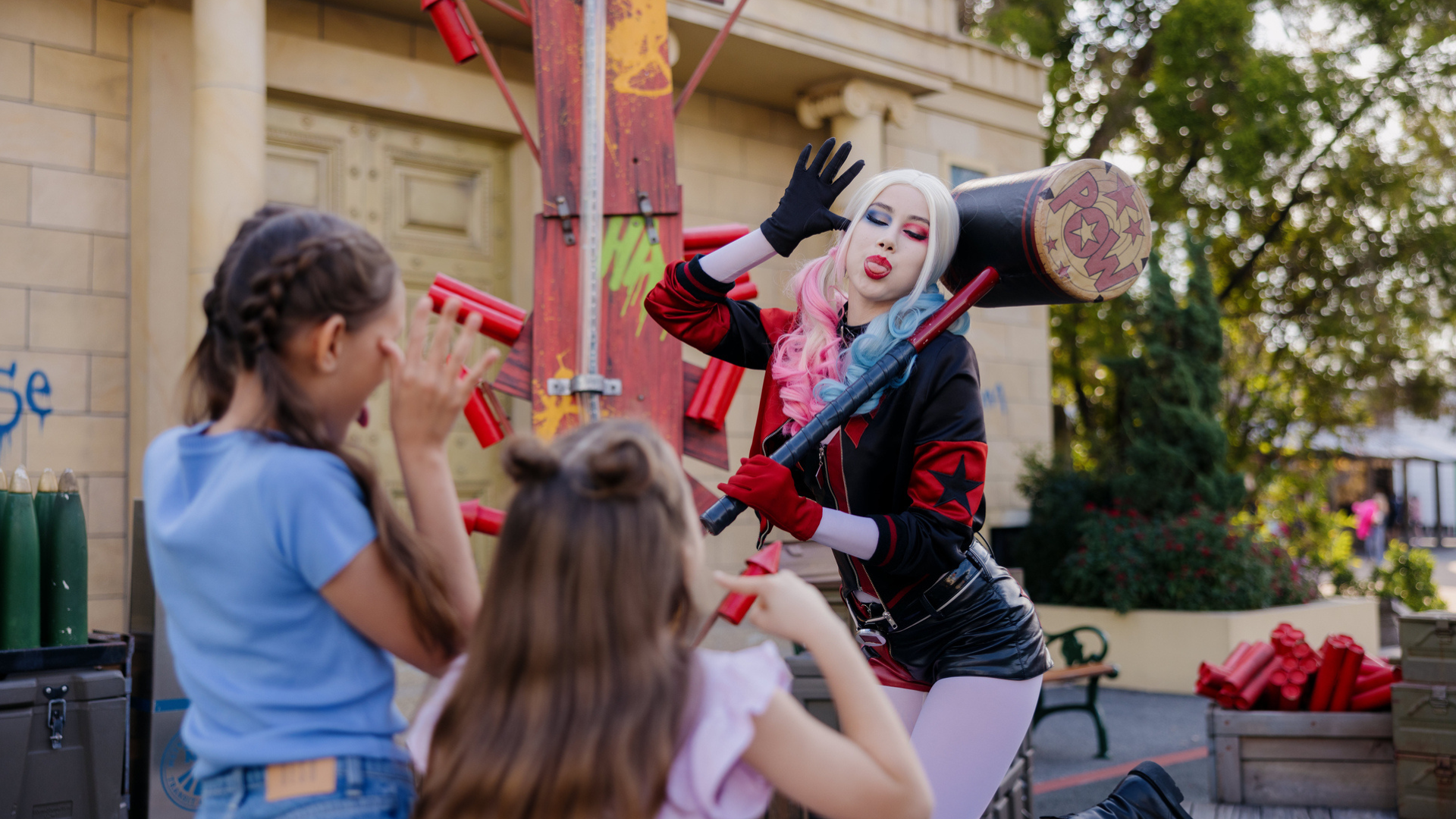 Harley Quinn smiling while holding her hammer over her shoulder at Warner Bros. Movie World
