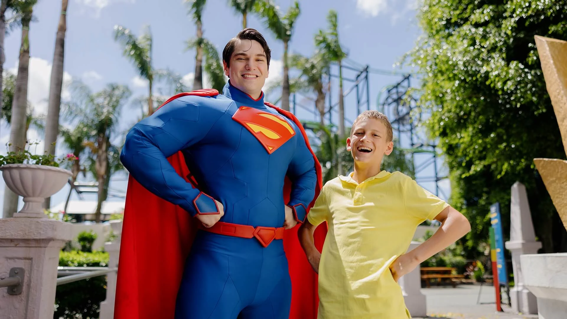 A boy posing with Superman, the iconic superhero, at Warner Bros. Movie World, capturing the magic of meeting a beloved character