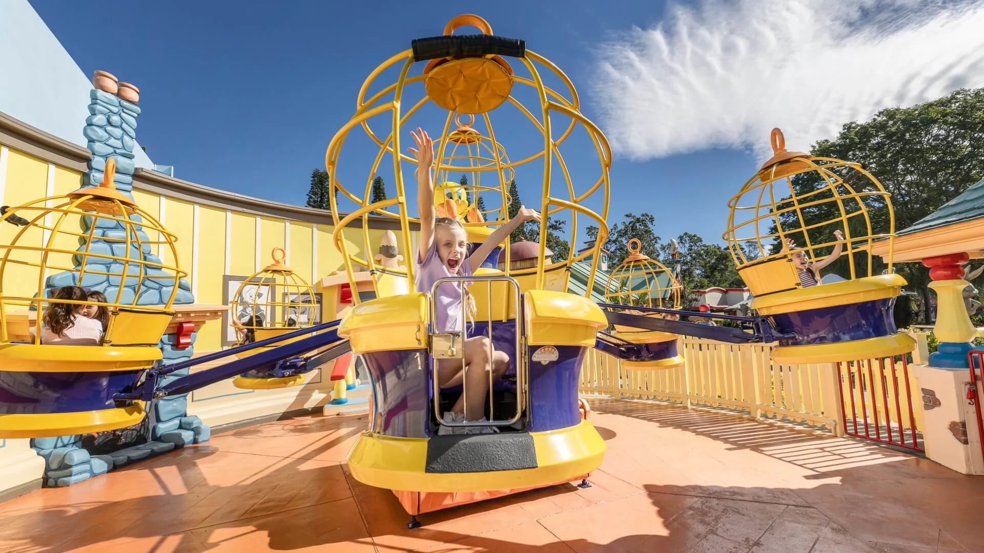 A happy mother and her son enjoying a ride in the Sylvester and Tweety Cages at Warner Bros. Movie World