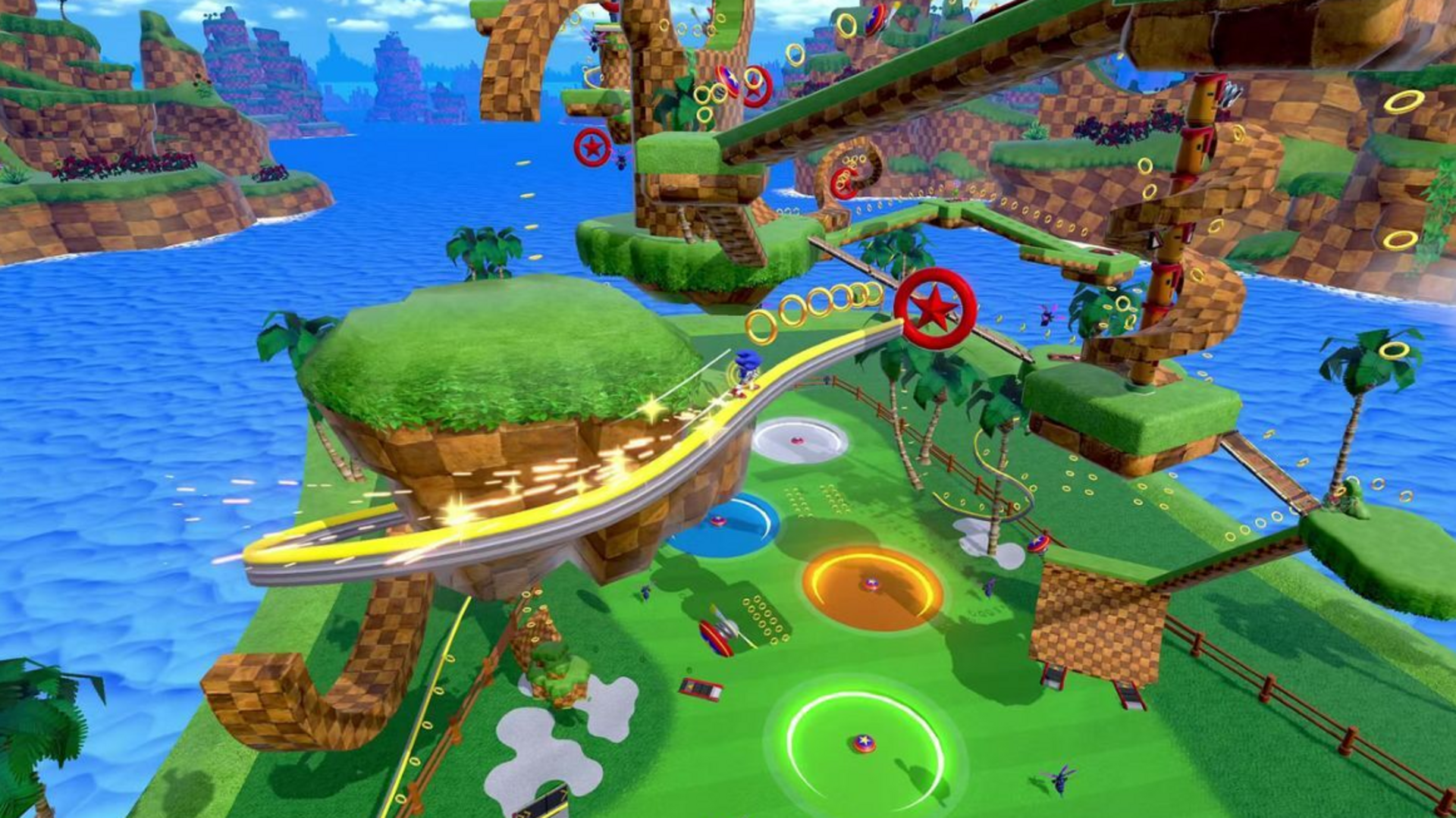 A vibrant, colorful video game scene shows a blue character speeding along a looping track above green hills, palm trees, and water, with golden rings and checkerboard-patterned platforms in the background.