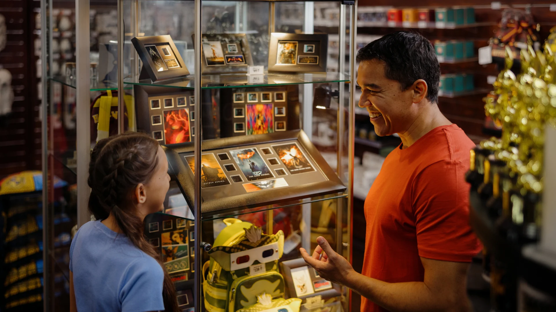 A couple browsing and looking at souvenirs in the Movie Memorabilia store at Warner Bros. Movie World, exploring themed merchandise inspired by iconic movies
