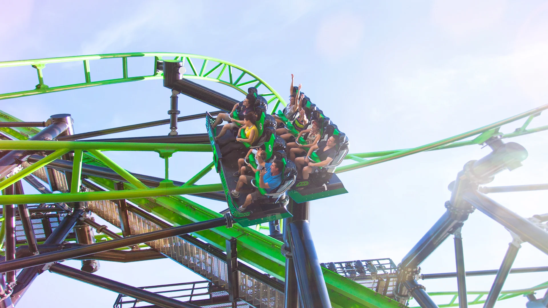 Thrilled riders twisting around a corner on the Green Lantern Coaster at Warner Bros. Movie World