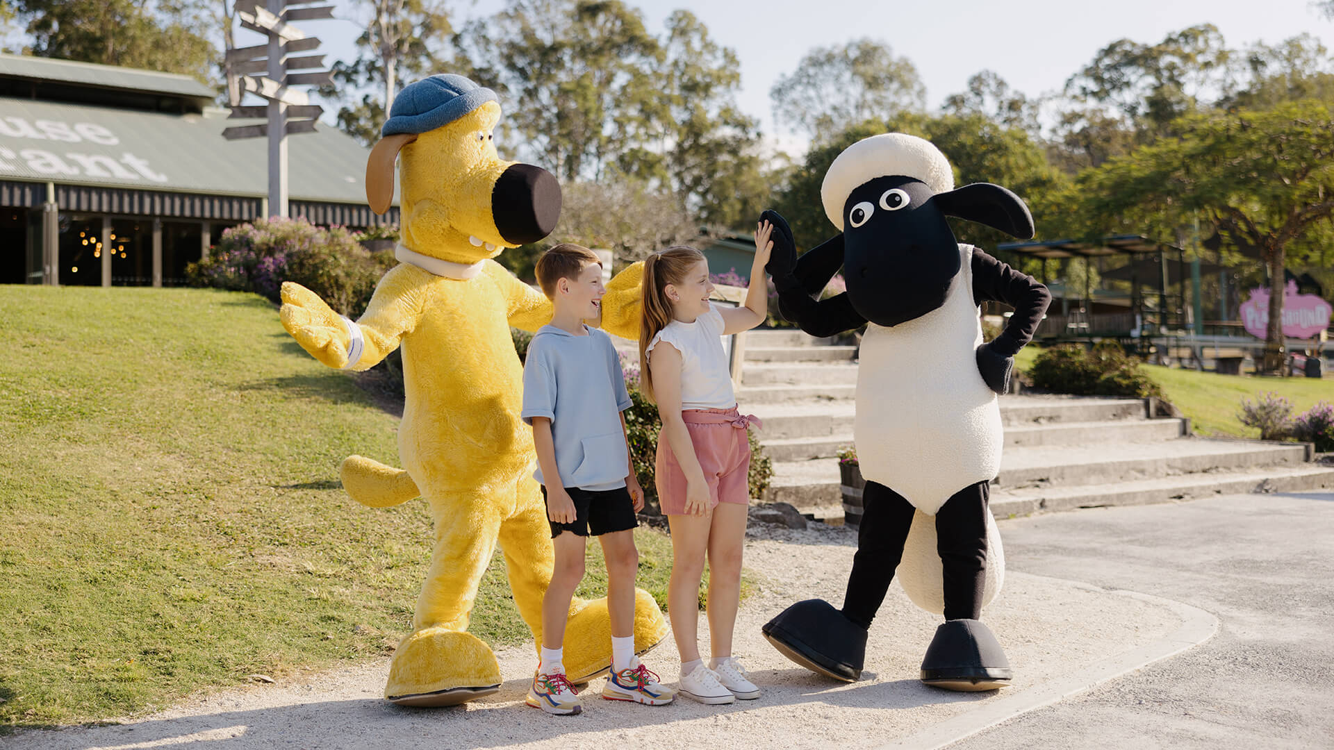 Kids meeting and high-fiving Shaun the Sheep and Bitzer characters during a fun family experience at Paradise Country.