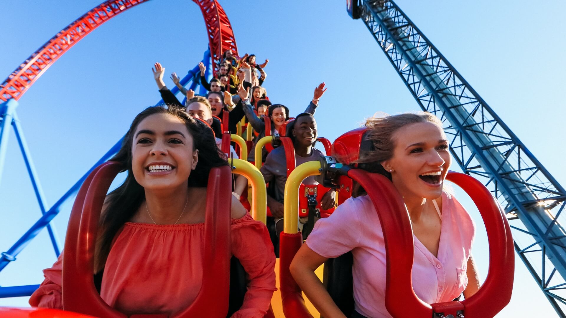 Passengers experiencing the thrilling descent on the Superman Escape ride at Warner Bros. Movie World, with excitement and anticipation visible as they plunge down the first hill of the high-speed coaster