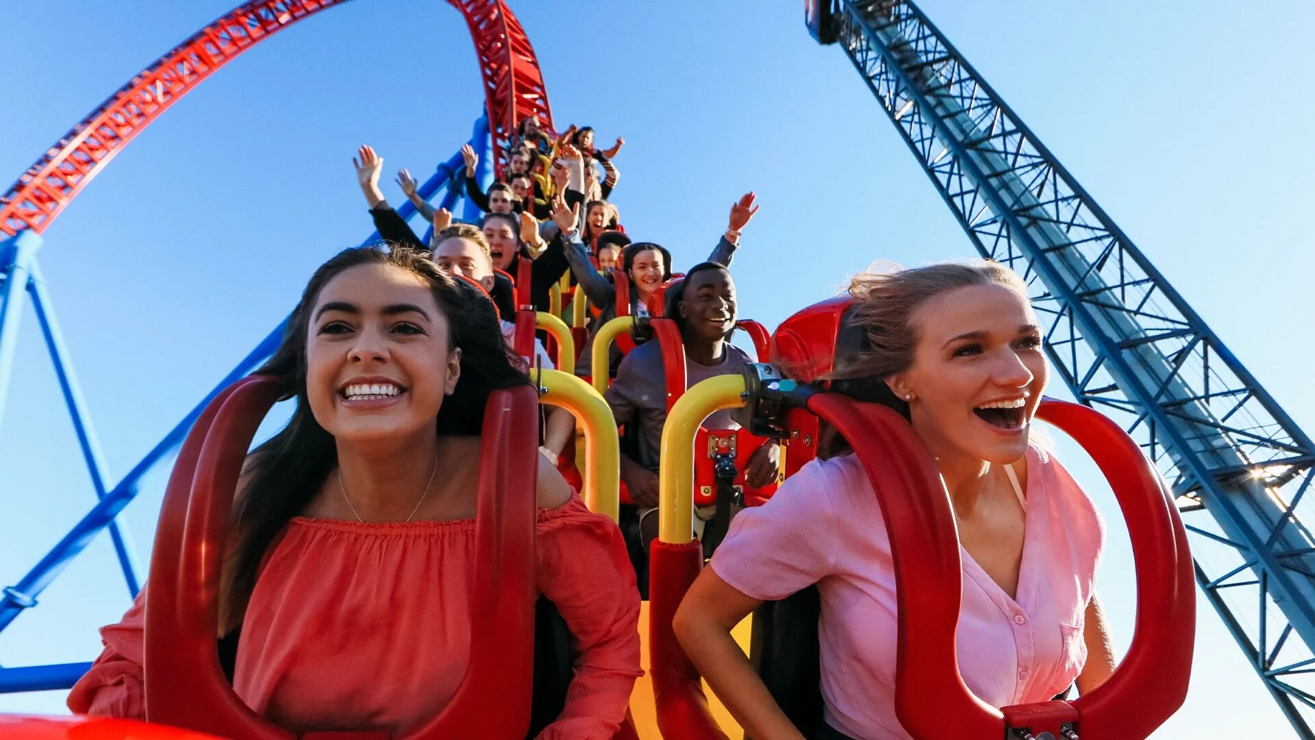 Passengers experiencing the thrilling descent on the Superman Escape ride at Warner Bros. Movie World, with excitement and anticipation visible as they plunge down the first hill of the high-speed coaster