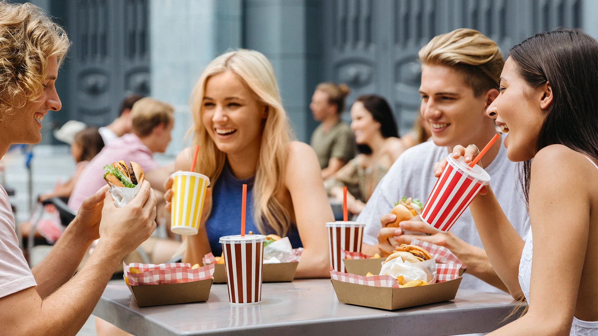 A group of friends enjoying food and drinks at Gotham City Cafe in Warner Bros. Movie World. Food and beverage