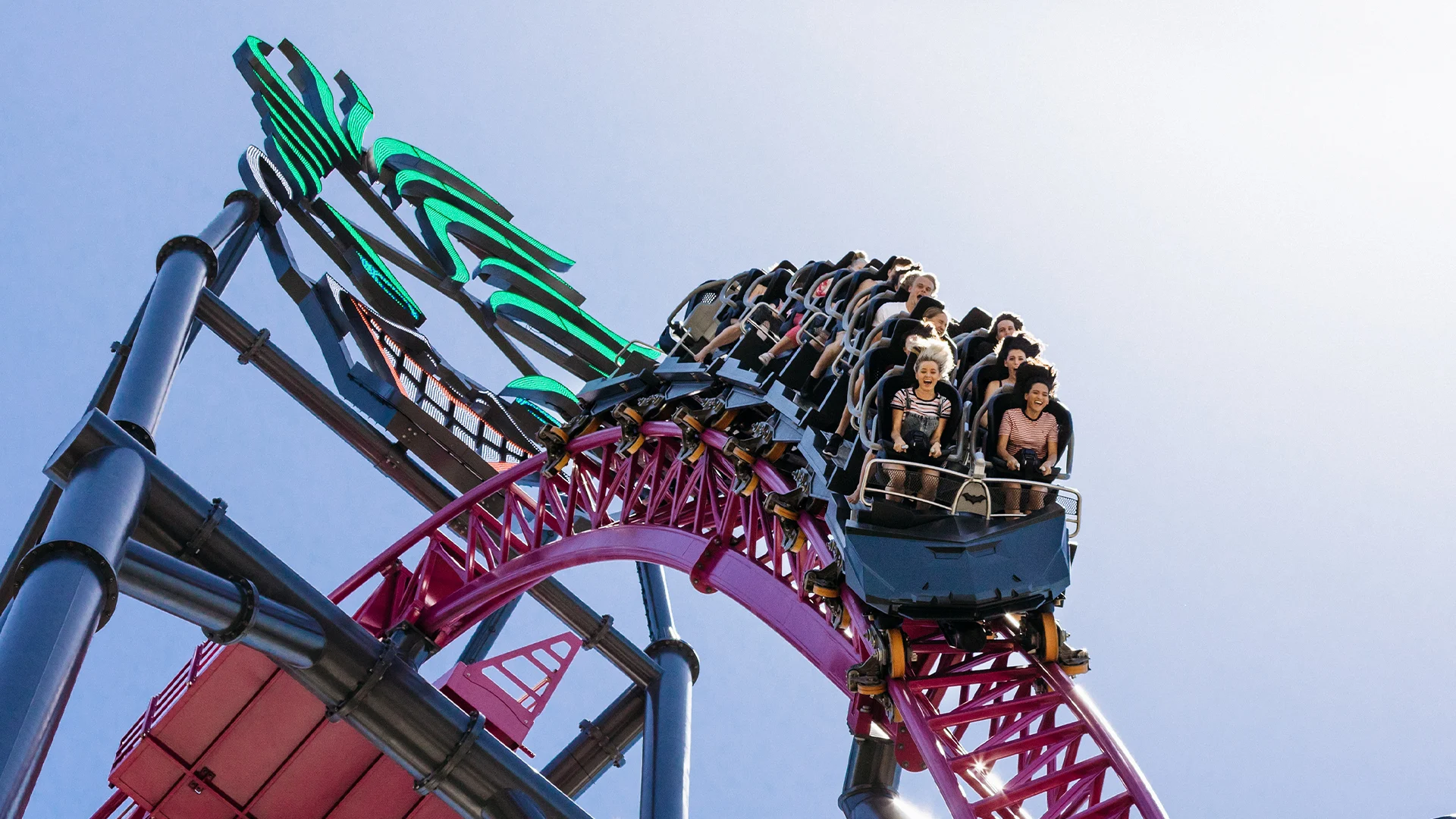 Thrilled riders descending down the main hill on the DC Rivals HyperCoaster at Warner Bros. Movie World, with exhilarating speed and excitement captured in the moment