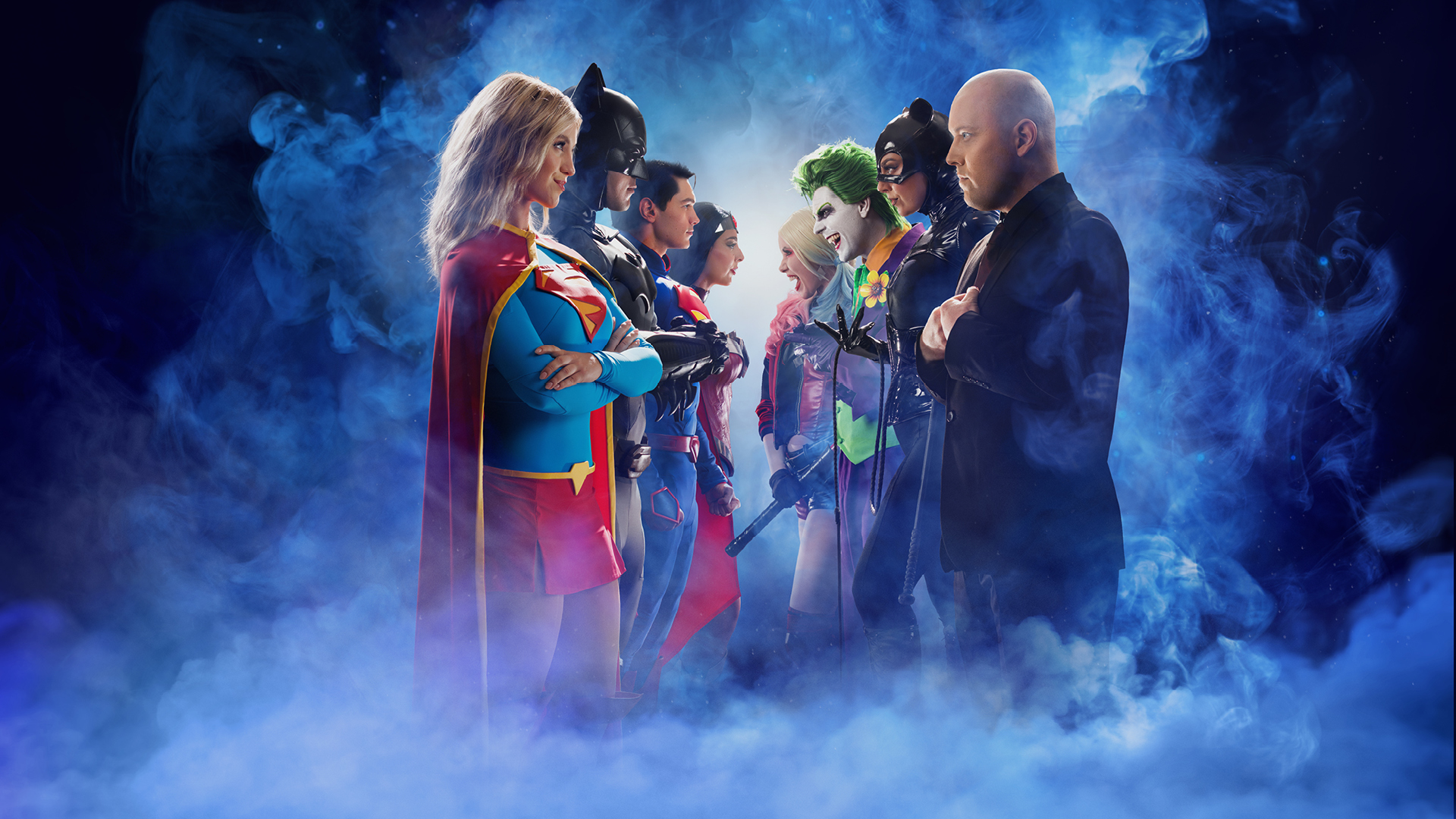 A group of superheroes, including a woman in a red cape and several in masks, face off against a line of villains amid swirling blue smoke, suggesting an intense standoff.