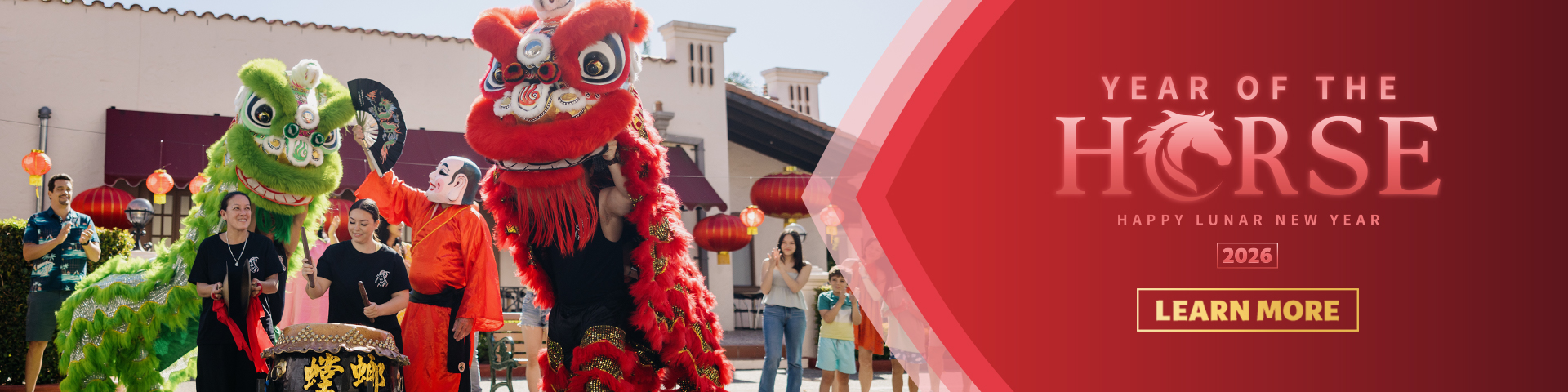 Lion dancers perform during a Lunar New Year celebration with people watching. Text reads, “Year of the Horse, Happy Lunar New Year 2026, Learn More” on a red background.