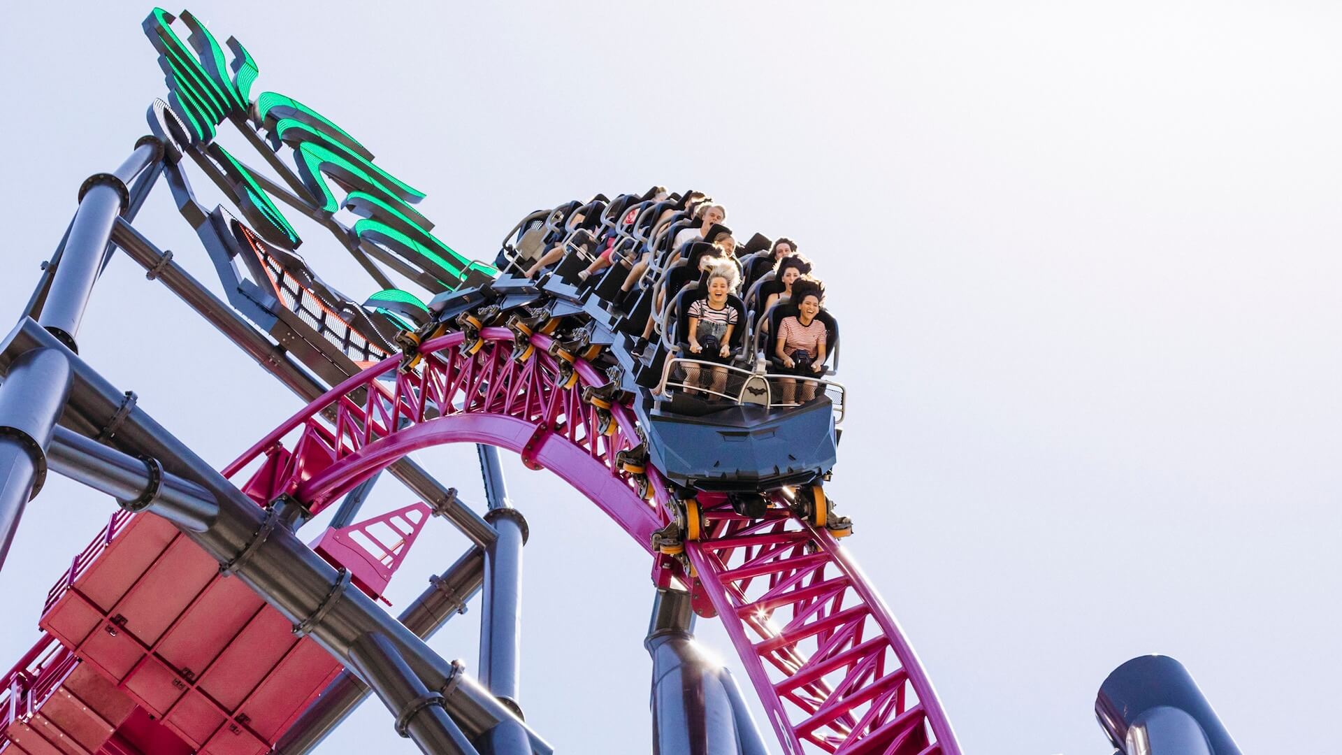 DC Rivals HyperCoaster thrillingly descending the first drop at Warner Bros. Movie World, with riders experiencing high-speed excitement and adrenaline rush