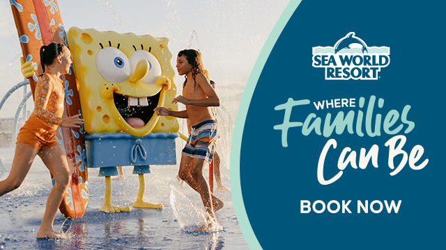 Two children play in water with a person in a SpongeBob SquarePants costume at Sea World Resort, alongside a banner reading "Where Families Can Be. Book Now.