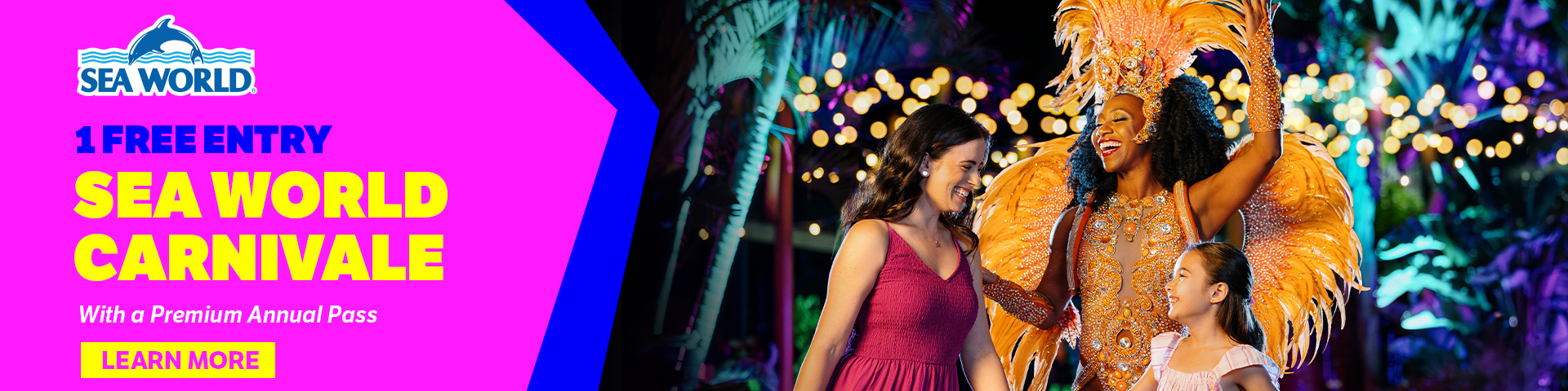 A smiling performer in a feathered orange costume greets a woman and a child at night. Text reads: “1 Free Entry Sea World Carnivale with a Premium Annual Pass. Learn More.” Sea World logo appears at top left.
