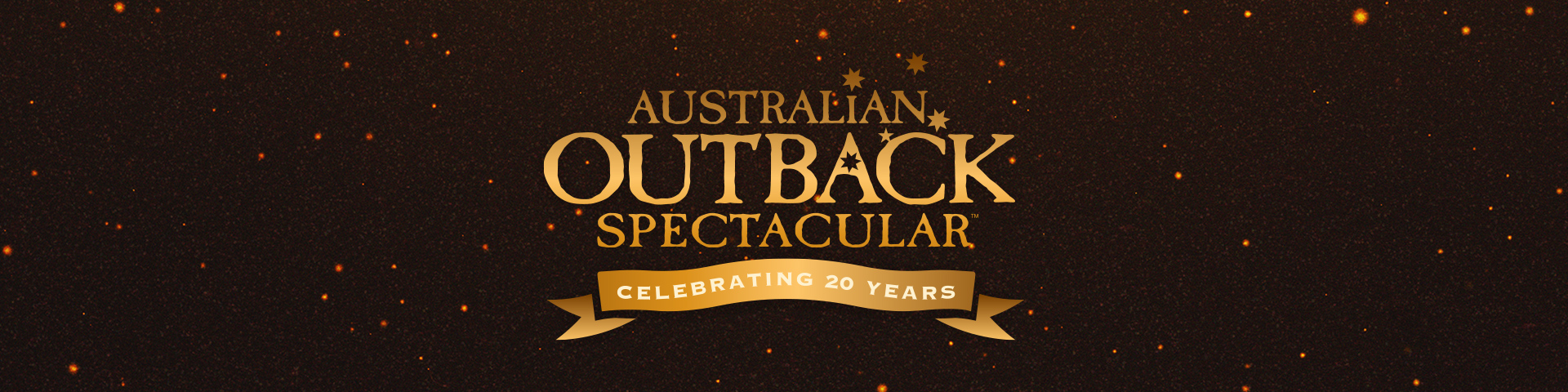 Gold text reads "Australian Outback Spectacular" with three stars, and a gold ribbon below says "Celebrating 20 Years" on a dark background with orange sparkles.