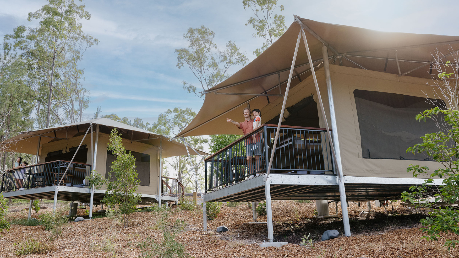 A man is standing on a balcony of an eco tent at Paradise Country Farmstay