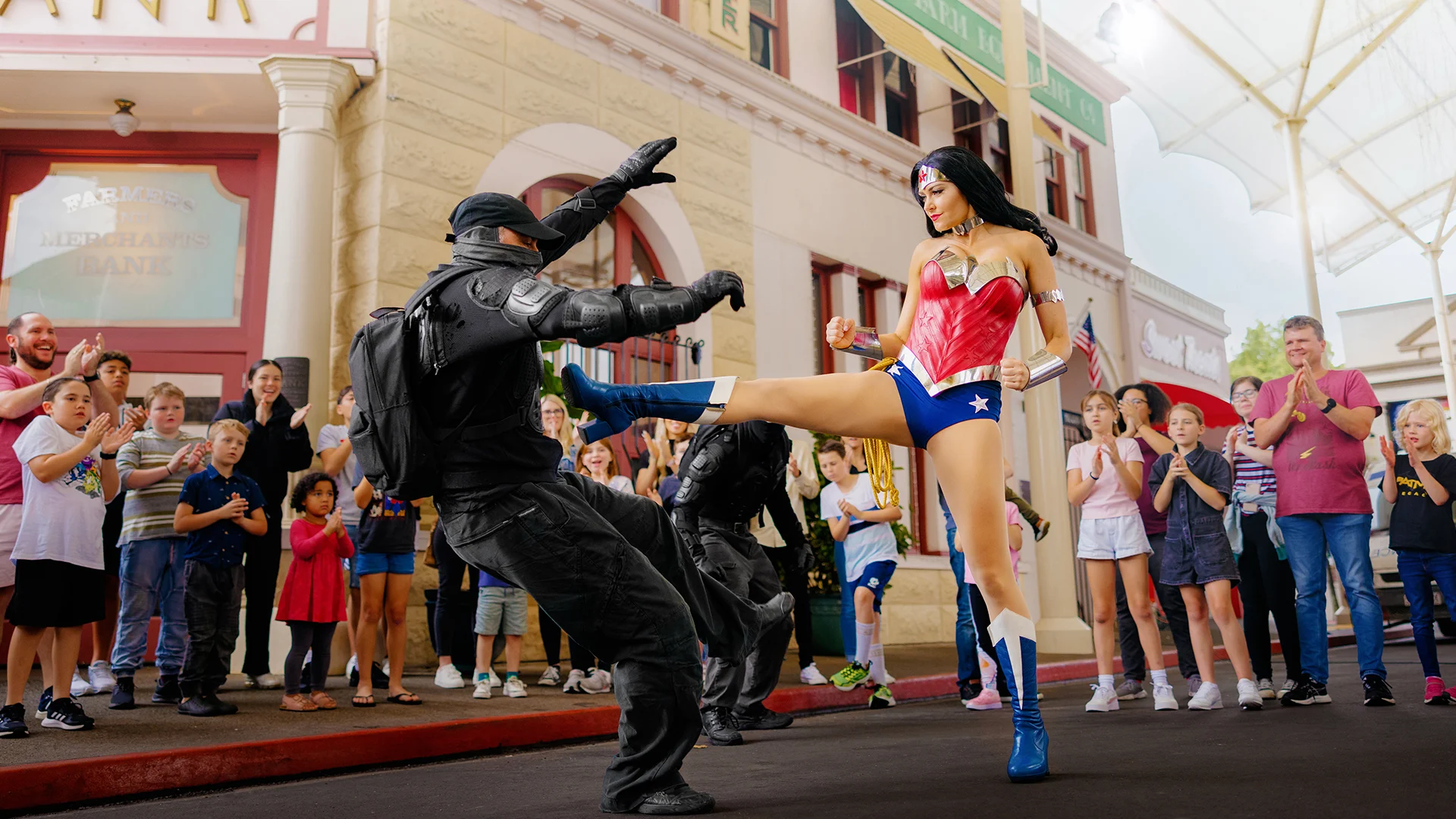 Wonder Woman fighting two mercenaries during a performance at Warner Bros. Movie World
