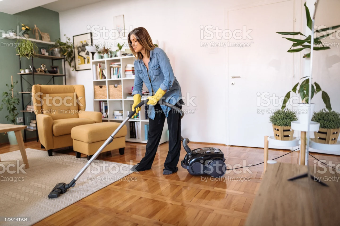 woman-vacuum-cleaning-the-living-room-and-cleaning-the-floors-picture-id1220441934