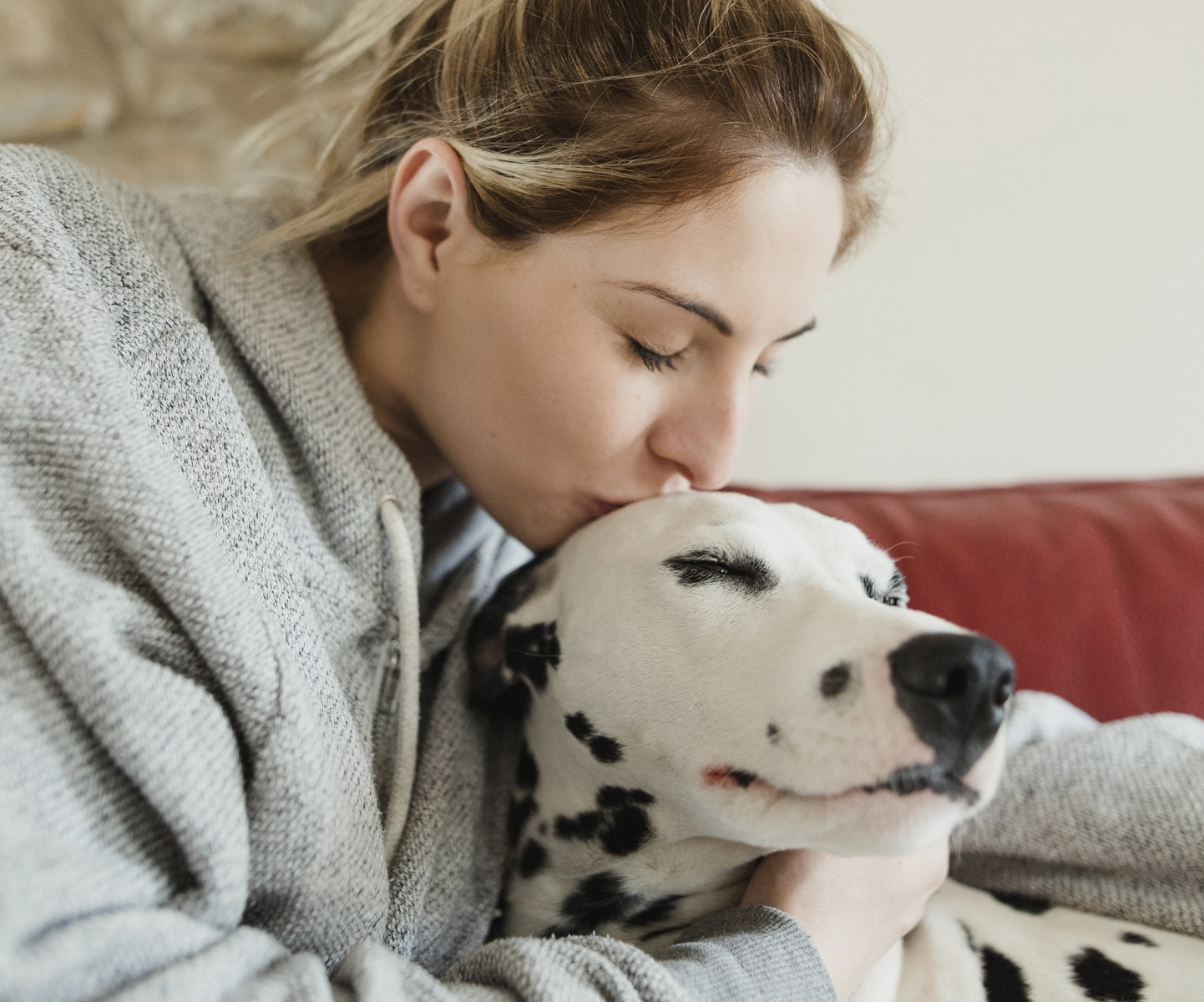 Surgery insurance - Pet parent kissing dog on head