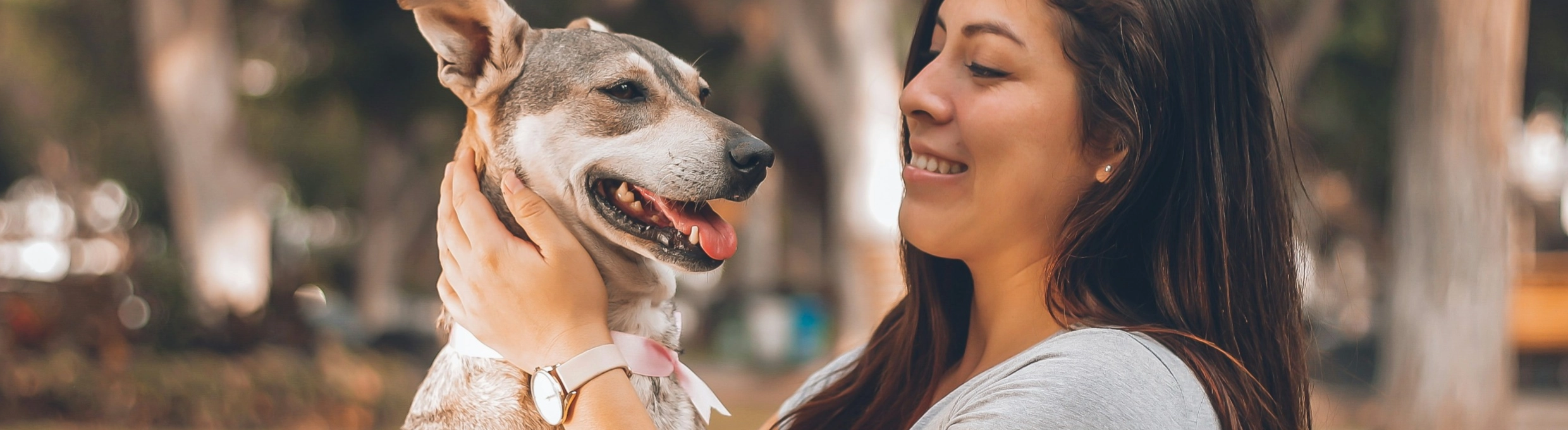 Woman holding happy dog