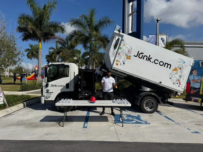 Junk.com crew member gives thumbs up before Miami Touch-A-Truck event at Divine Savior Academy of Doral.