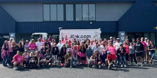 Group photo at the 2025 10th Annual Sonja Rileas Breast Cancer Walk benefiting the Ray of Hope Cancer Foundation in Colorardo Springs with the Junk.com truck in the background.