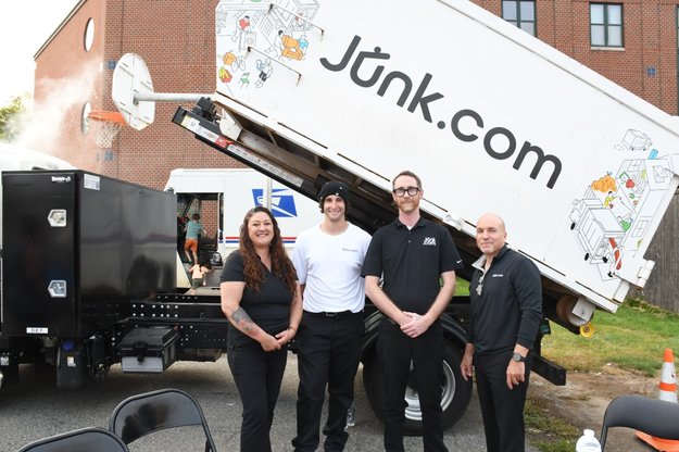 Junk team from Boston show off the junk truck at the Touch-A-Truck zone during Medford, MA's National Night Out.