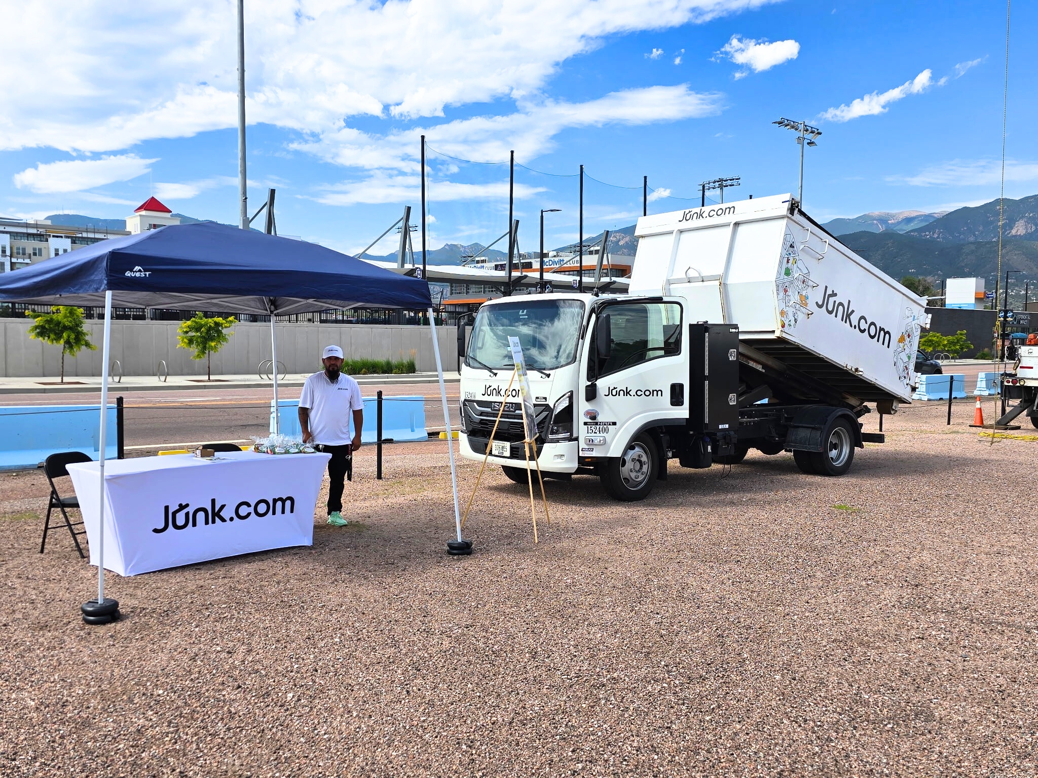 Junk.com team member waits by the Junk.com truck for families at Colorado Springs community event benefiting veterans.