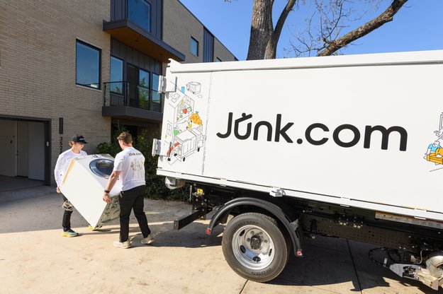 Junk.com hauls off an old electric washer from an apartment.