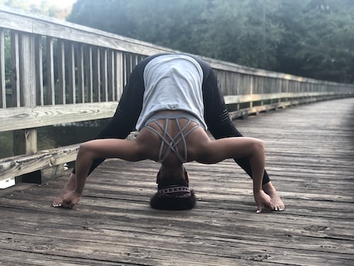 Person doing yoga on a bridge.