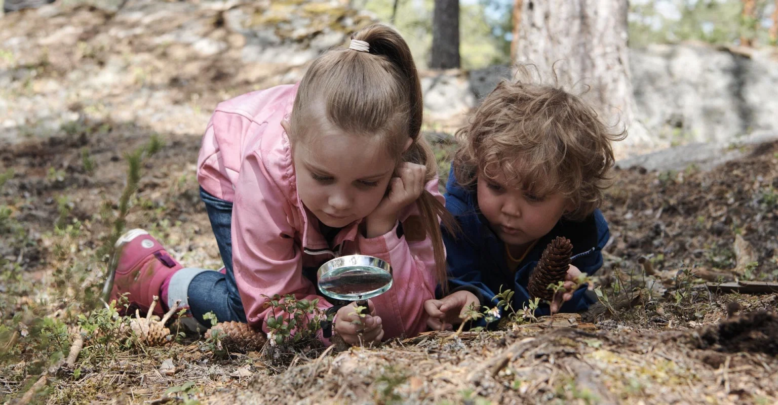 children-observing-plants-in-nature-feeling-less-stressed.jpg