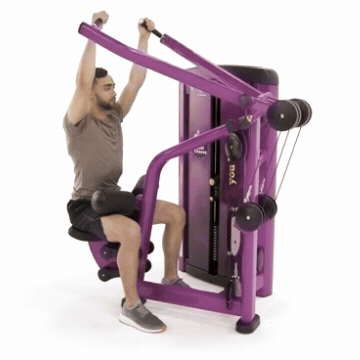 Man sitting on Planet Fitness lat pulldown machine and performing exercise