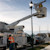 Construction workers fixing road light