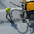 Road construction worker maintaining road by crack sealing