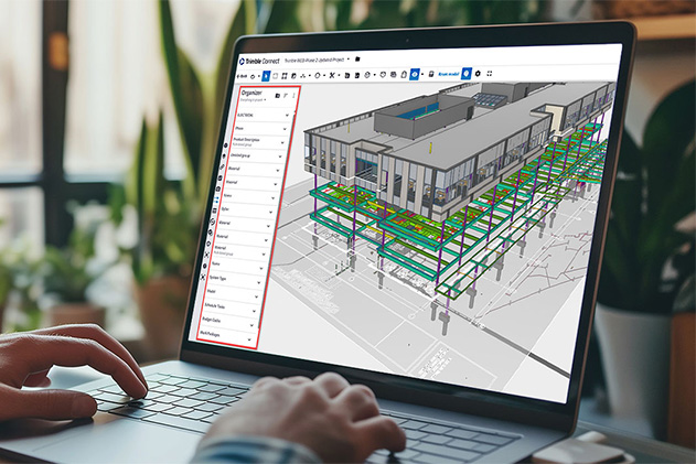 Hands on a laptop keyboard with the screen showing Trimble Connect software with a 3D building model and a data organizer panel.