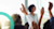 People raising their hands in classroom