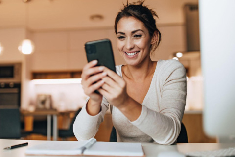 Professional woman checking notifications on phone