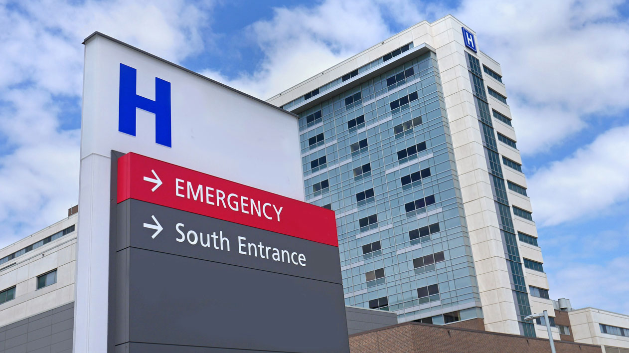 Exterior of hospital building with sign for Emergency & South Entrance.