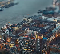 Aerial view of a brightly lit city near river