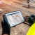 Construction worker holding tablet on road