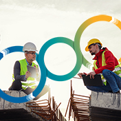 Two construction workers in hard hats and safety vests are looking at a laptop and tablet, with abstract circular graphics overlaid.