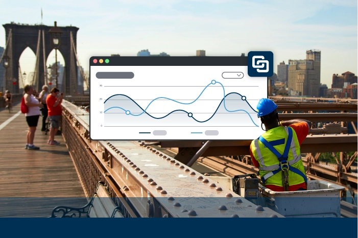 Worker on bridge with software showing line chart